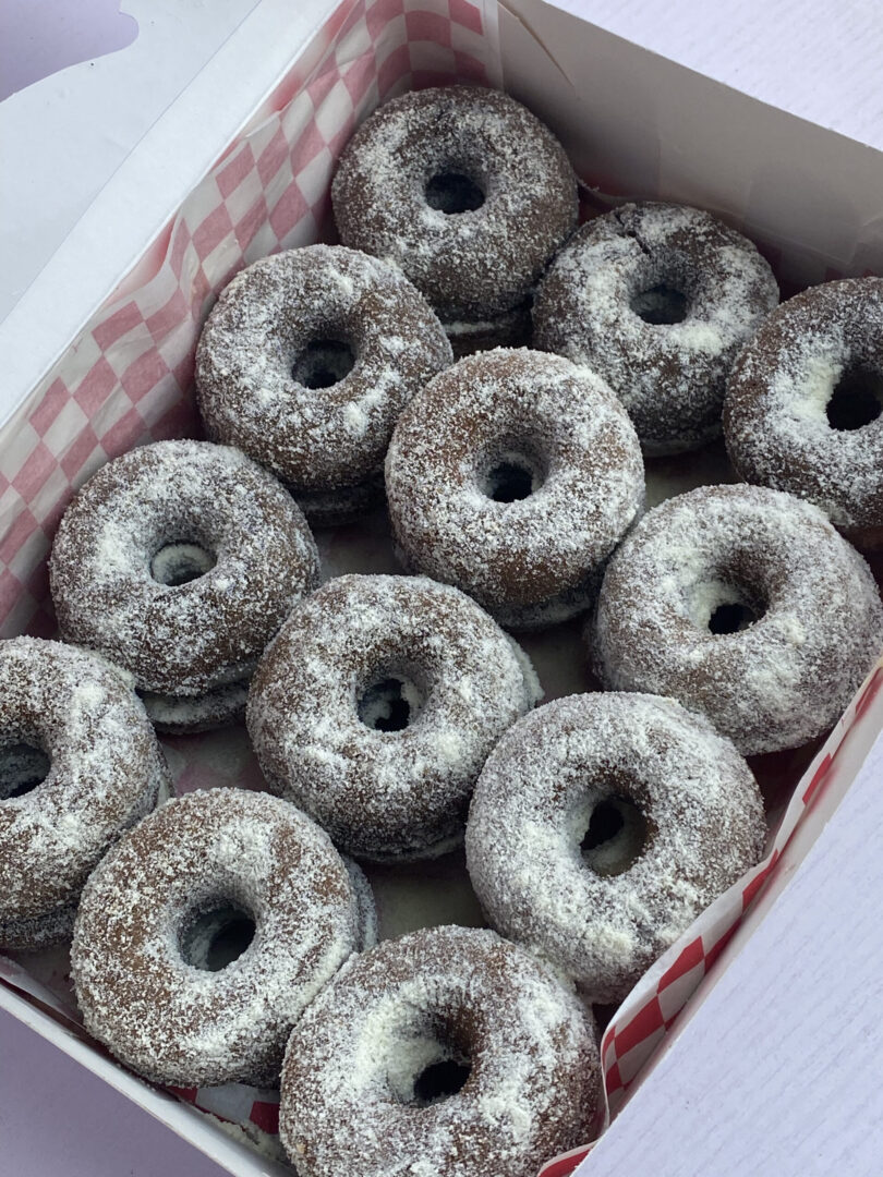 Box of 24 baked chocolate doughnuts